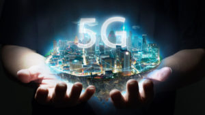 Image of hands holding a representation of the 5G network.