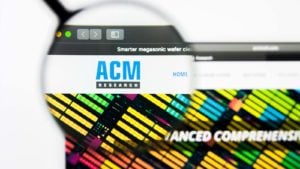 a magnifying glass enlarges the ACM logo on a website