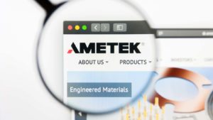 A magnifying glass zooms in on the Ametek, Inc. (AME) logo