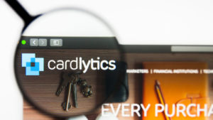 a magnifying glass zooms in on the Cardlytics logo on the company website