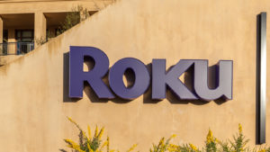 The Roku logo on the side of an office building comprised of sand colored concrete representing ROKU stock.