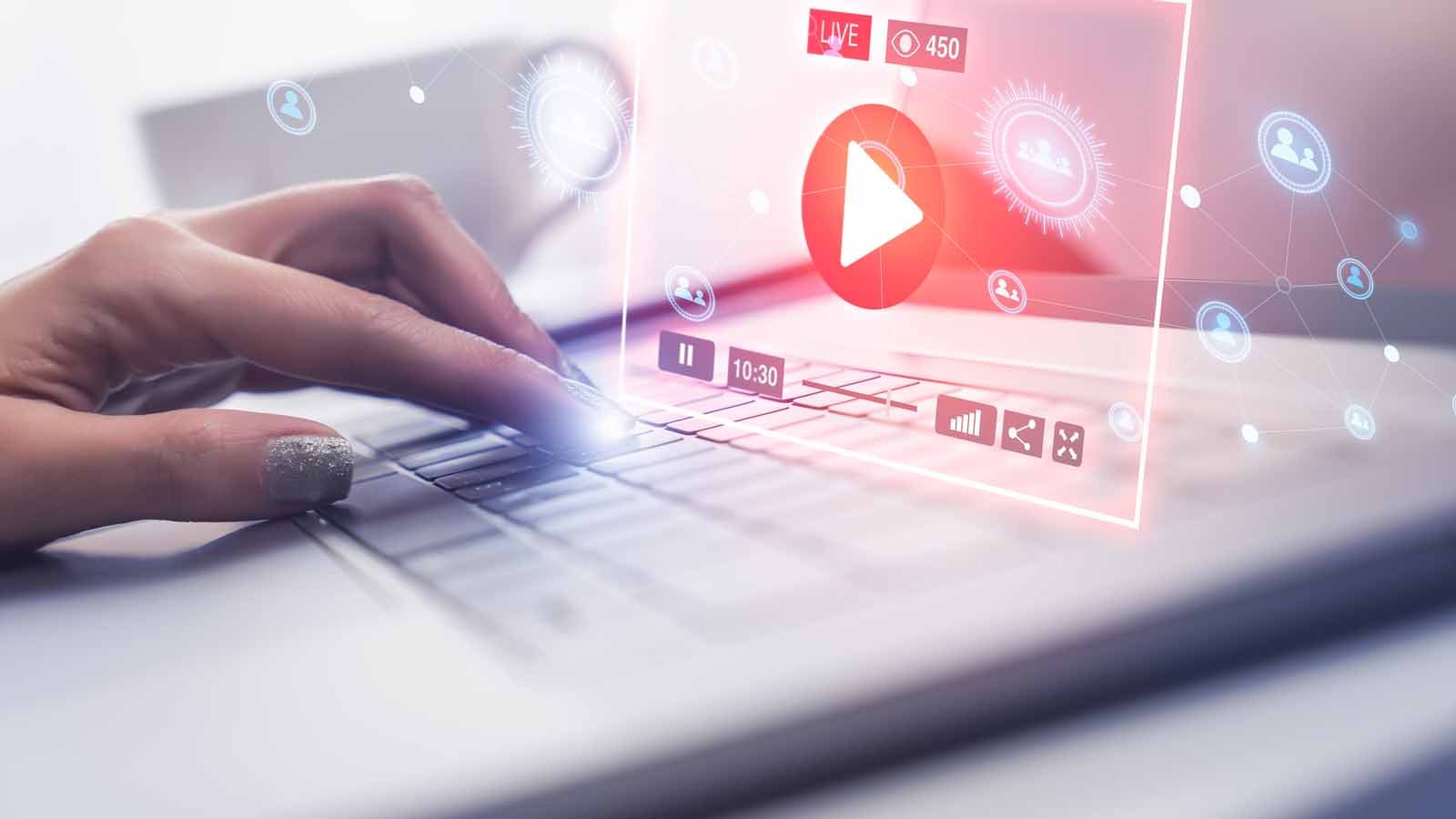 WISA Stock. Image of a person pressing a button on a laptop and a holographic projection of a music player appearing to represent streaming stocks