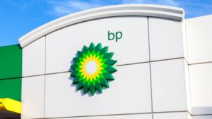 BP stock: the BP company logo on a building. Blue-Chip Stocks