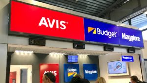 the avis logo displayed at an airport