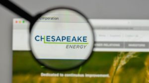 Image of an internet browser with Chesapeake Energy's (CHK) homepage on it. The Chesapeake Energy logo on the page is amplified by a magnifying glass.