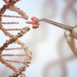 Gene editing stocks: a concept image of a hand holding a pair of tweezers that is pulling a section off of a dna strand