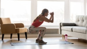 Image of a woman working out in her living room