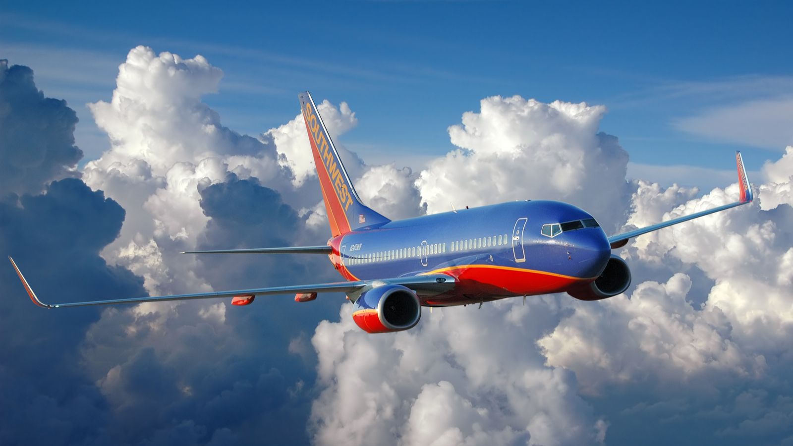 a southwest airline stocks (LUV) jet flying above the clouds
