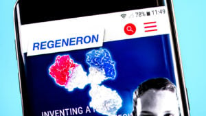 Regeneron (REGN) website displayed on a smartphone screen against a blue background.