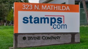 Stamps.com (STMP) sign on grass in front of building