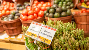 Image of vegetables in baskets at a store.