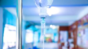IV drip in hospital hall representing therapeutics