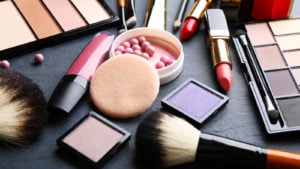 a collection of various cosmetic products on a black table. micro-cap stocks to buy