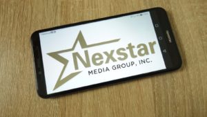 Nexstar (NXST) Media Group logo on a phone screen