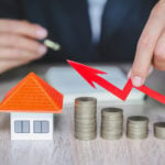 a stack of coins and red arrow pointing up to a house figure to represent crowdfunding real estate