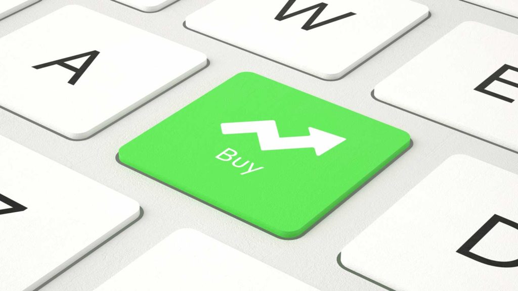 a green button on a keyboard has an arrow pointing upward with the word "Buy". representing safe stocks to buy