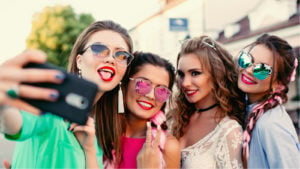 Image of teenaged girls attractive a selfie on a shopping trip.