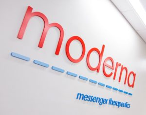 An image of the Moderna, Inc. (MRNA) logo on a white wall