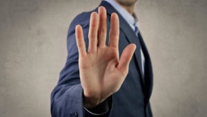 hand of man in suit signaling stop