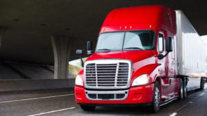 a red 18-wheel truck driving on the highway