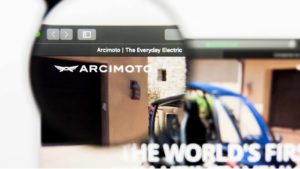 Image of Arcimoto's (FUV) logo amplified by a magnifying glass on the company's home web page.