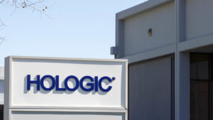 Hologic (HOLX) sign outside next to a building