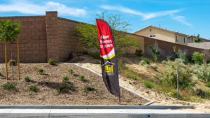 Located in the Mojave Desert City of Victorville, California, a feather flag sign for LGI Homes with text of New Homes - 0% Down. (<a href=