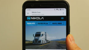 the Nikola website homepage on a cell phone screen (electric car stocks)