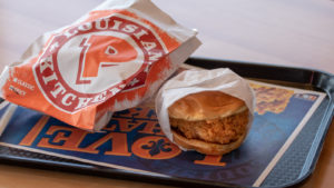 a tray of food from popeyes. Shares to buy at dip