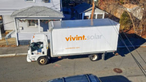 A Vivint Solar (VSLR) installation truck parked out front of a residence.