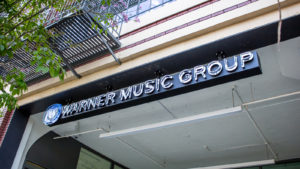 Image of an office building with the warner music group (WMG) logo on the outside