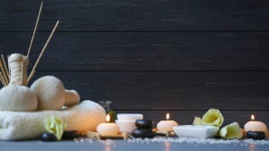 spa stones and lit candles lined up in a row