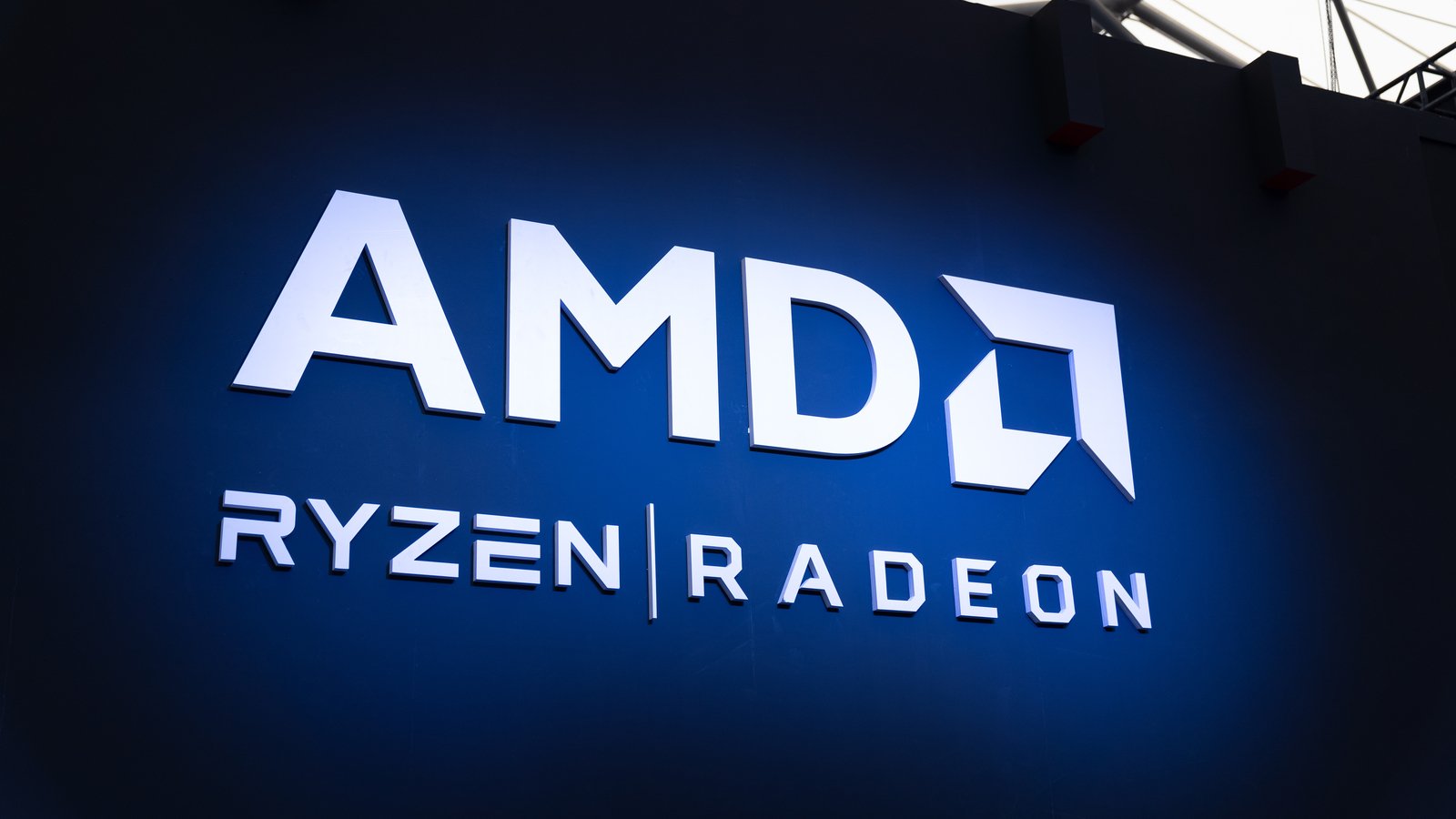 Advanced Micro Devices (AMD stock) logo on blue background with Ryzen and Radeon brands