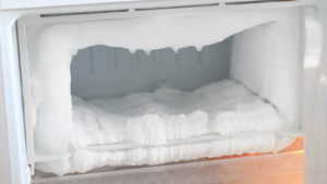 Ice full in empty freezer of a refrigerator makes refrigerator work harder and broken.