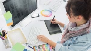 High angle view of an artist drawing something on graphic tablet at the office.