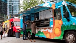 Two colorful food trucks are parked in Atlanta, Georgia.