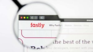 A magnifying glass zooms in on the Fastly (FSLY Stock) website.