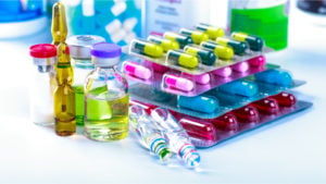 colorful pills and vials sitting on a table representing PTE stock.