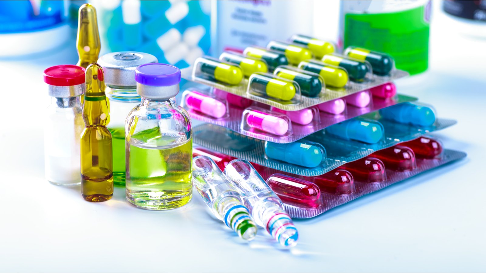 colorful pills and vials sitting on a table representing VTGN stock