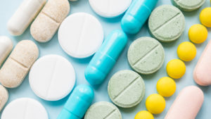 rows of pills on a table representing pharmaceutical stocks