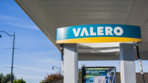 A daytime picture of a Valero (VLO) gas station located in San Francisco bay and clear blue sky in the background.