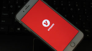 Vroom app is open on a smartphone. Vroom is a used car retailer and e-commerce company that enables consumers to buy, sell & finance cars online