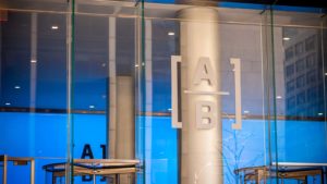 The AllianceBernstein logo inside a corporate office in New York City.