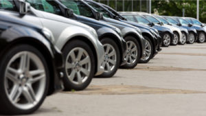 An angled side view of a row of parked cars.