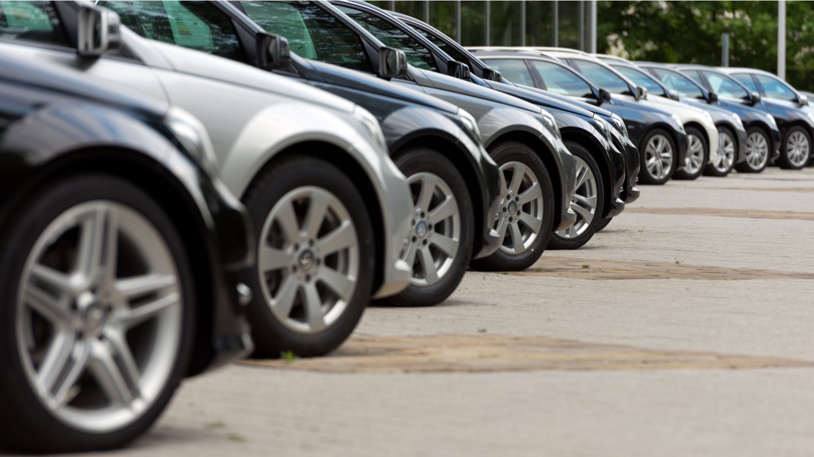 An oblique side view of a row of parked cars.