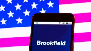 The Brookfield Renewable Partners (BEP) logo is displayed on a smartphone screen in front of a digital American flag background.