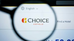 A magnifying glass zooms in on the Choice Hotels (<a href=