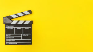 Clapperboard against a yellow background