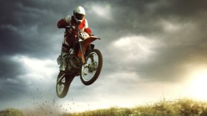 a person on a dirt bike does a jump