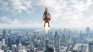 Businessman in suit and aviator hat flying on rocket.